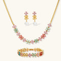 Gold-plated jewelry set with pink, turquoise and red flower-shaped cubic zirconia stones, featuring necklace, earrings and bracelet.