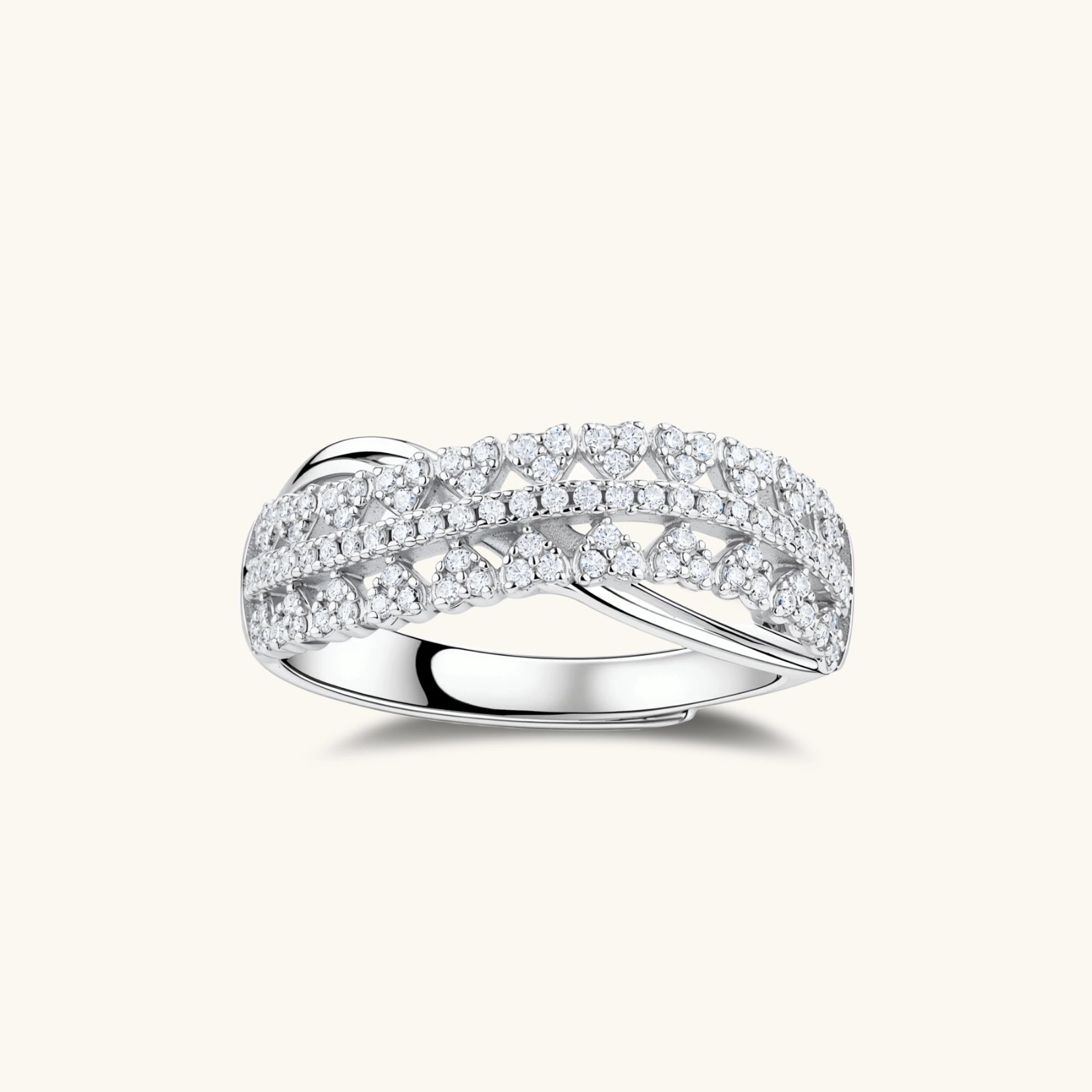Sterling silver crossover ring with pavé-set moissanite stones creating an elegant infinity design on neutral background