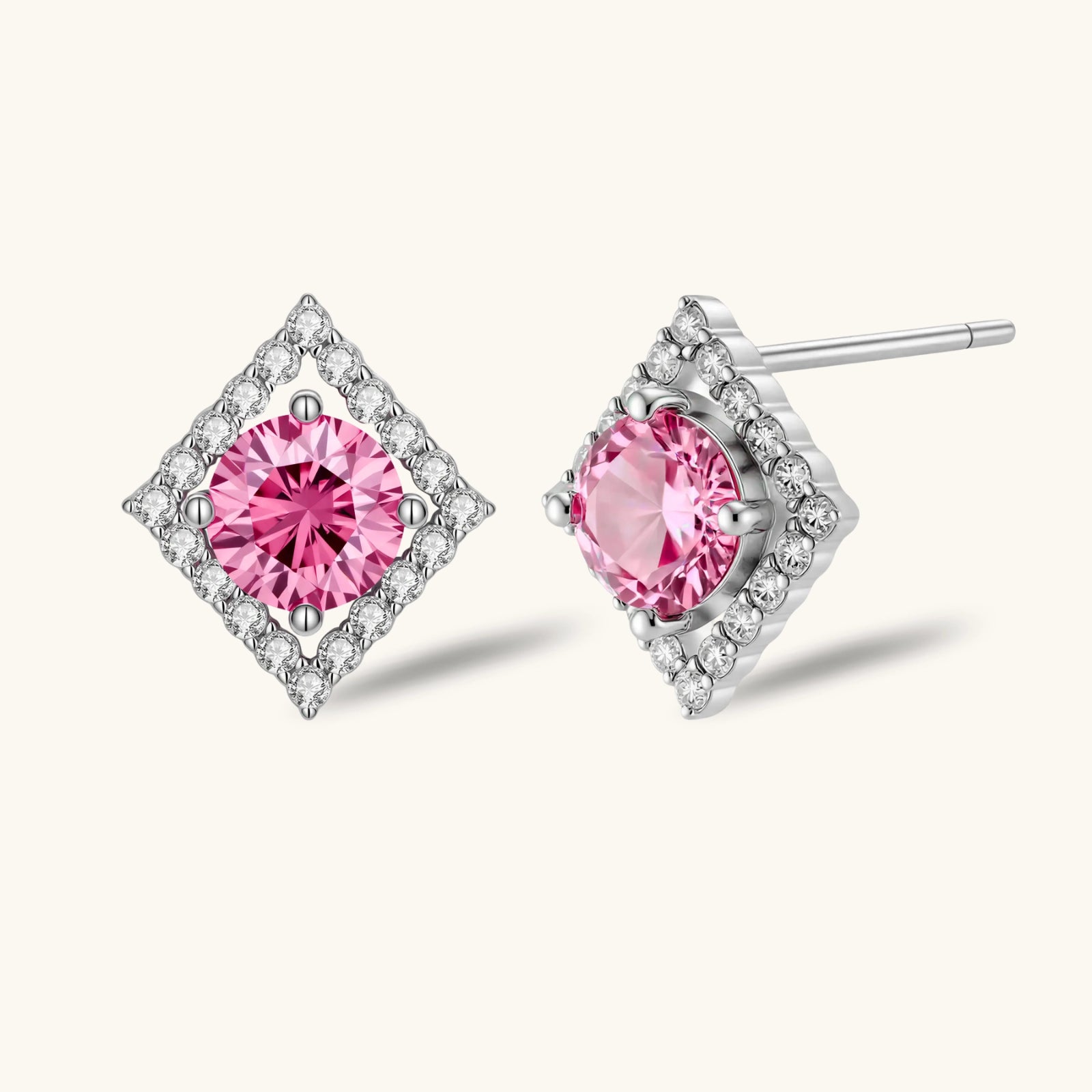 Sterling silver diamond-shaped stud earrings with pink moissanite center stones and crystal halo setting on white background