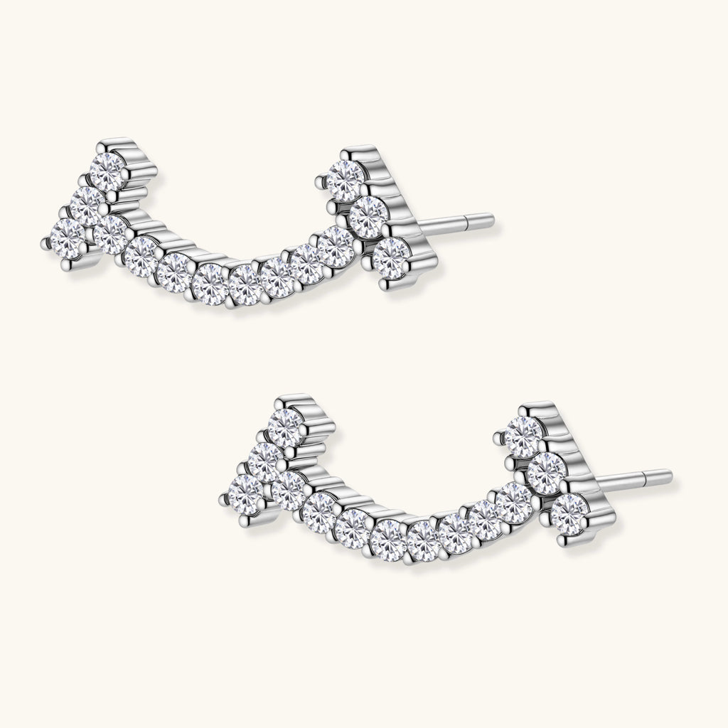 Curved sterling silver ear climbers with moissanite stones arranged in elegant arc shape on white background