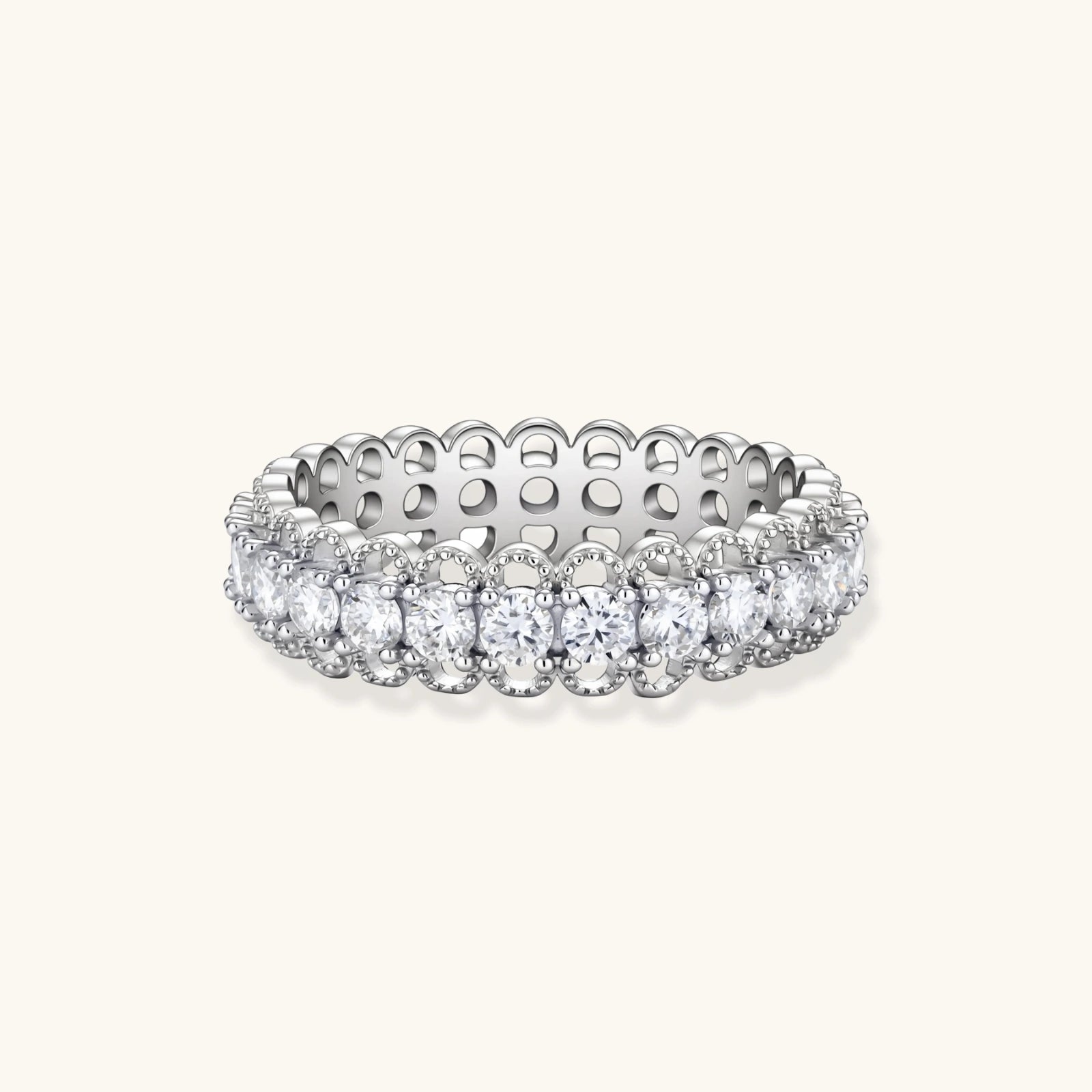 Sterling silver eternity ring with continuous row of brilliant moissanite stones in scalloped crown setting with milgrain detail