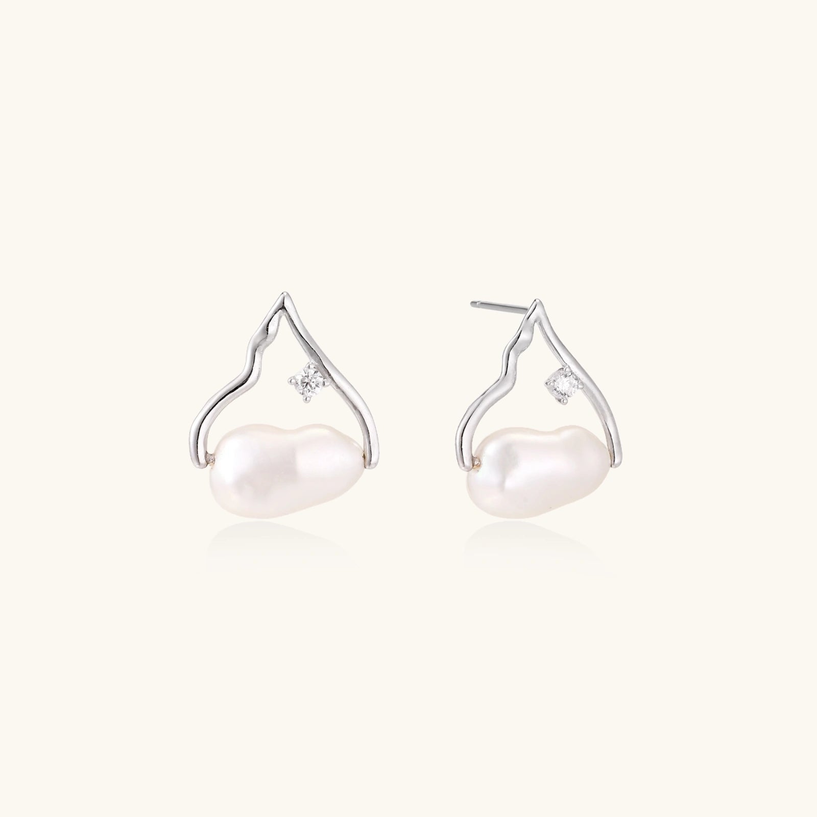 Silver mountain outline studs with baroque pearl and diamond accent on white background