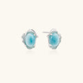 Oval larimar gemstone studs with ornate silver settings showing natural turquoise marbling on cream background