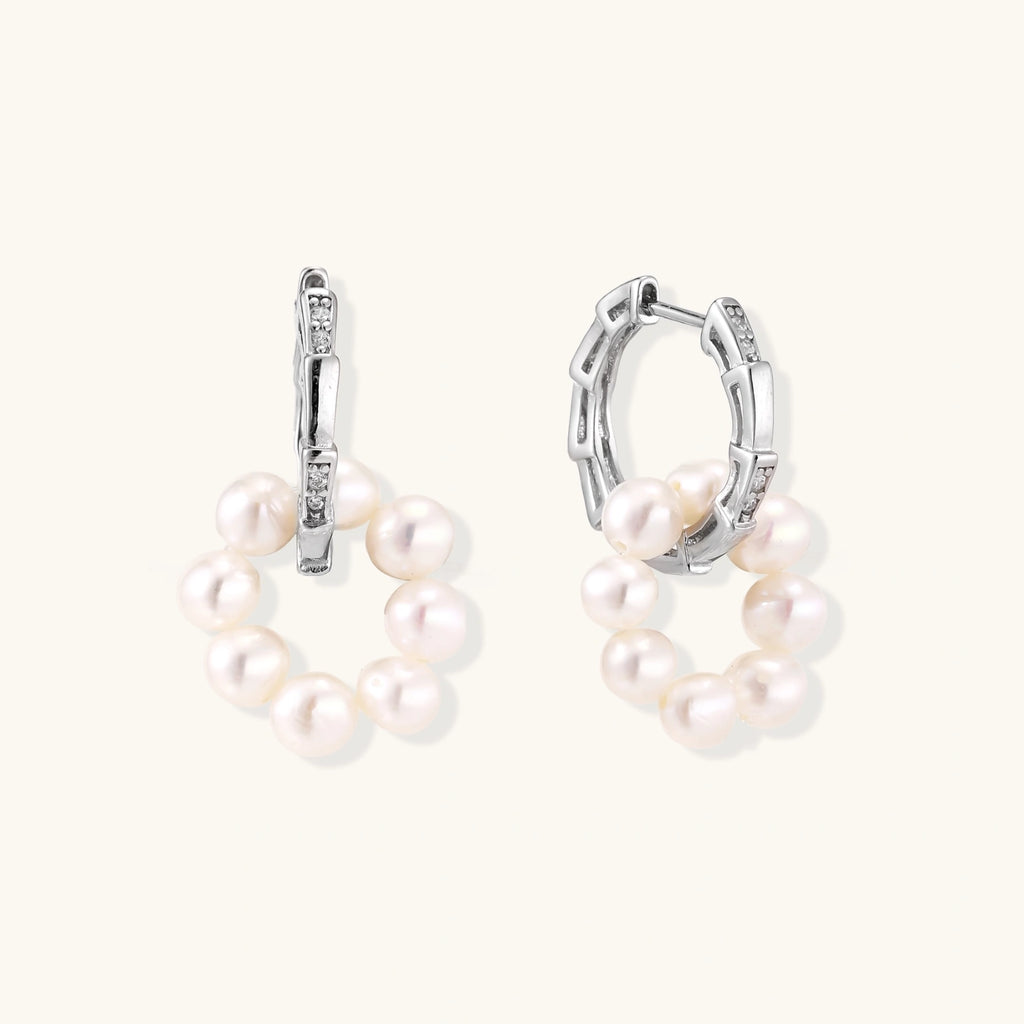 Rhodium-plated silver hoop earrings with freshwater pearls arranged in crescent formation and diamond accents