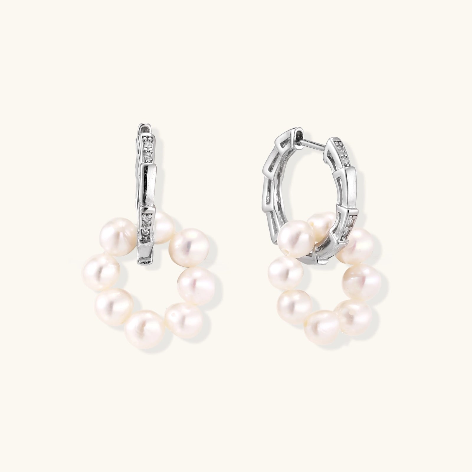 Rhodium-plated silver hoop earrings with freshwater pearls arranged in crescent formation and diamond accents