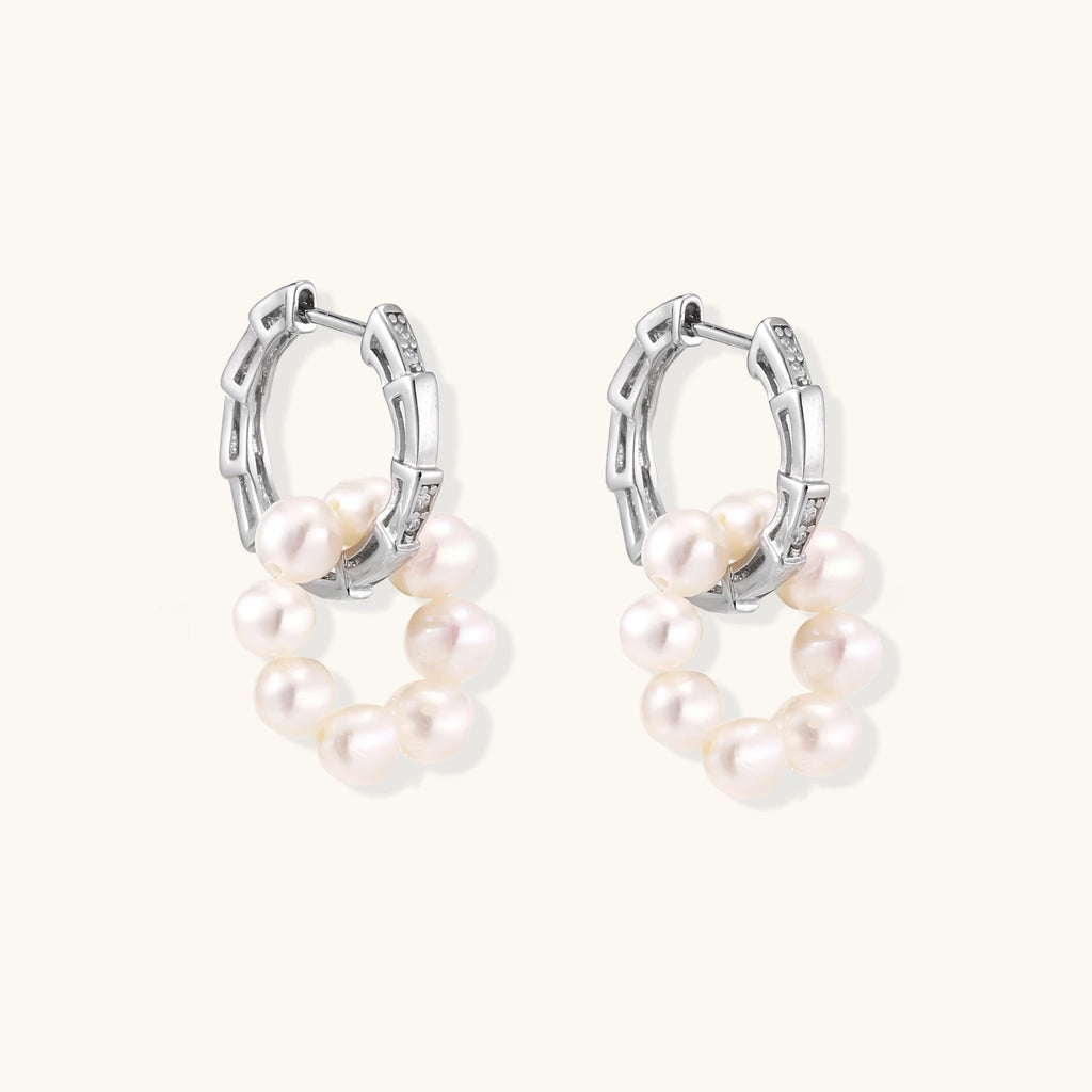 Rhodium-plated silver hoop earrings with freshwater pearls arranged in crescent formation and diamond accents