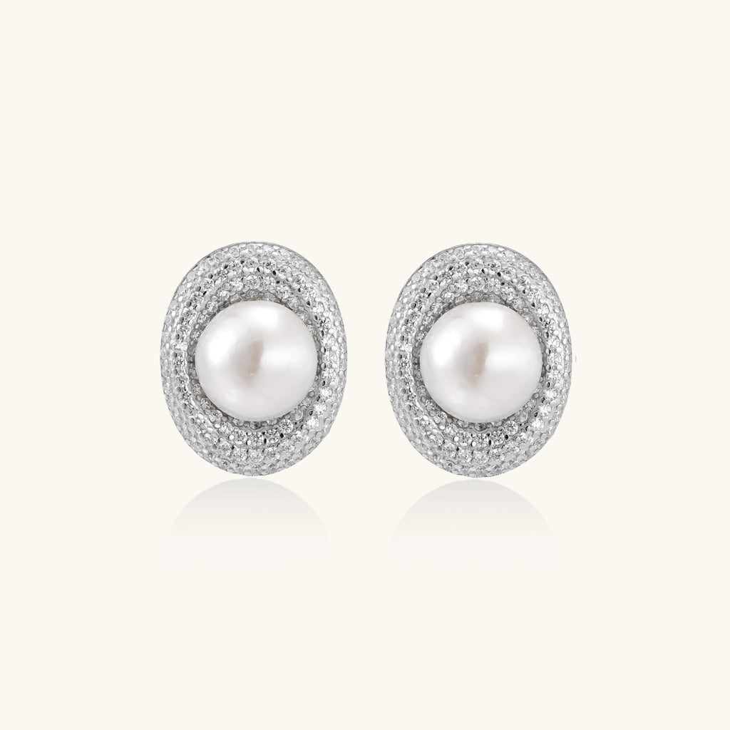 Elegant stud earrings with cream freshwater pearls surrounded by sparkly pavé crystals on rhodium-plated silver setting