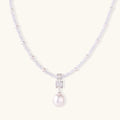 Dainty necklace with lavender crystal beads, freshwater pearls, geometric pendant, and large pearl drop on white background.