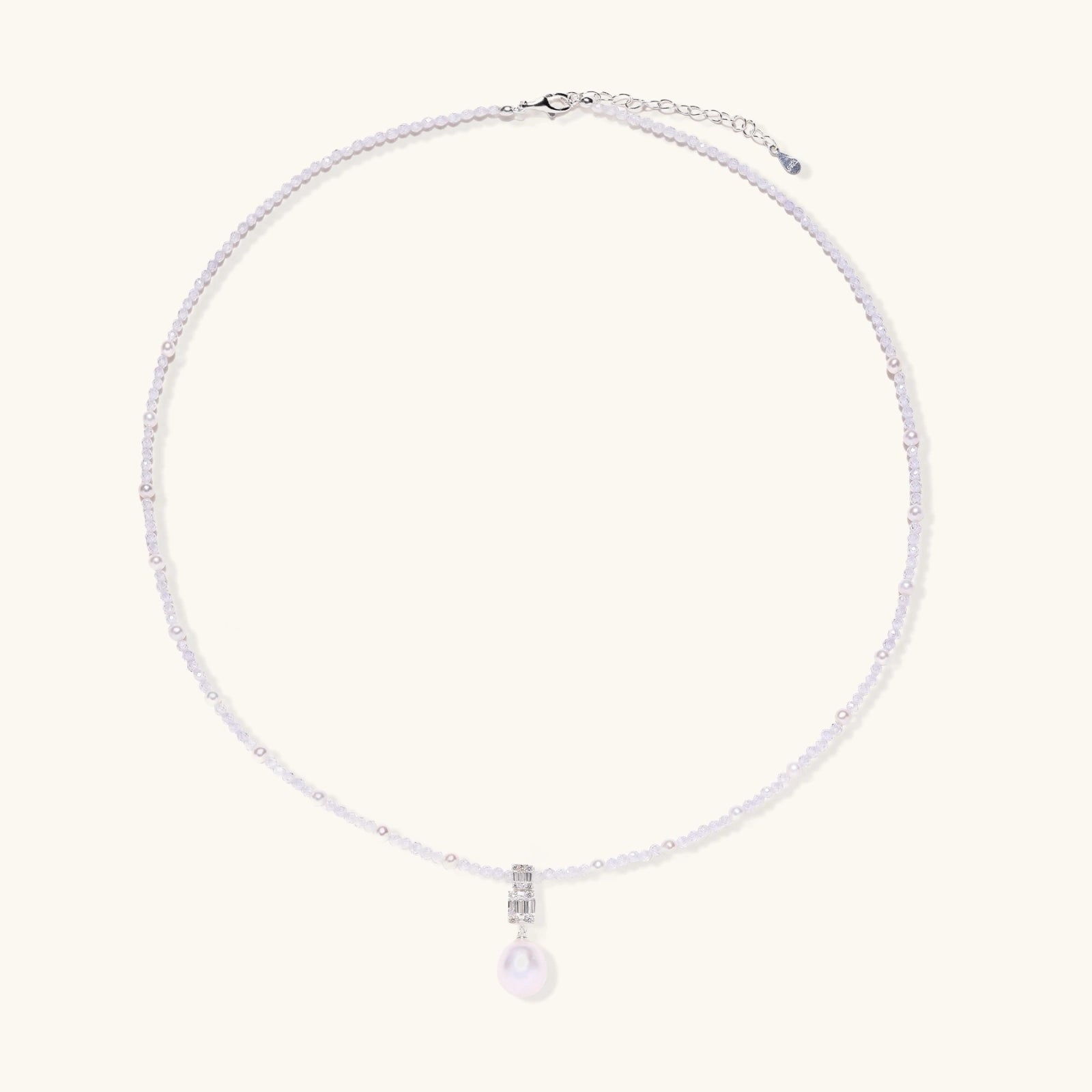 Dainty necklace with lavender crystal beads, freshwater pearls, geometric pendant, and large pearl drop on white background.