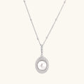 Oval sterling silver pendant with crystal halo surrounding a white freshwater pearl on delicate chain