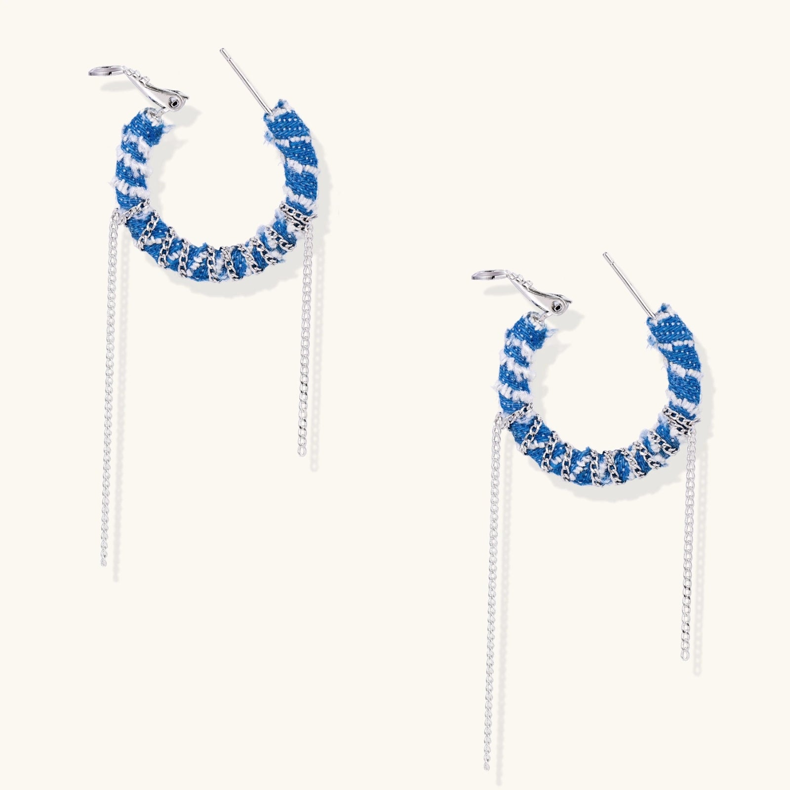 Medium hoop earrings wrapped in blue striped denim fabric with dangling silver chains on white background.