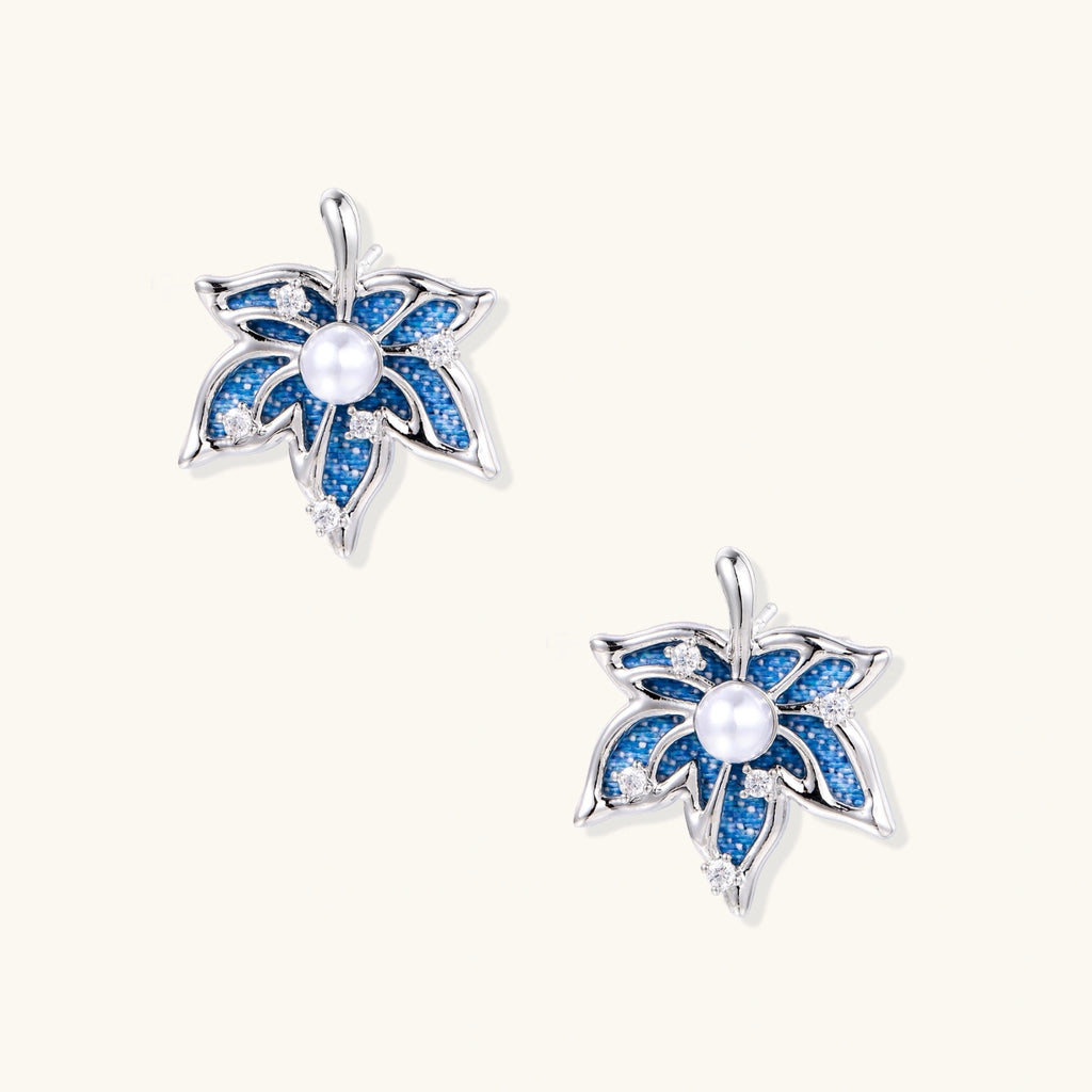 Blue denim fabric star-flower stud earrings with white pearl center and crystal accents on white gold-plated frame