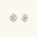 Ornate sterling silver stud earrings with mandala-inspired filigree pattern and four freshwater pearls on beige background