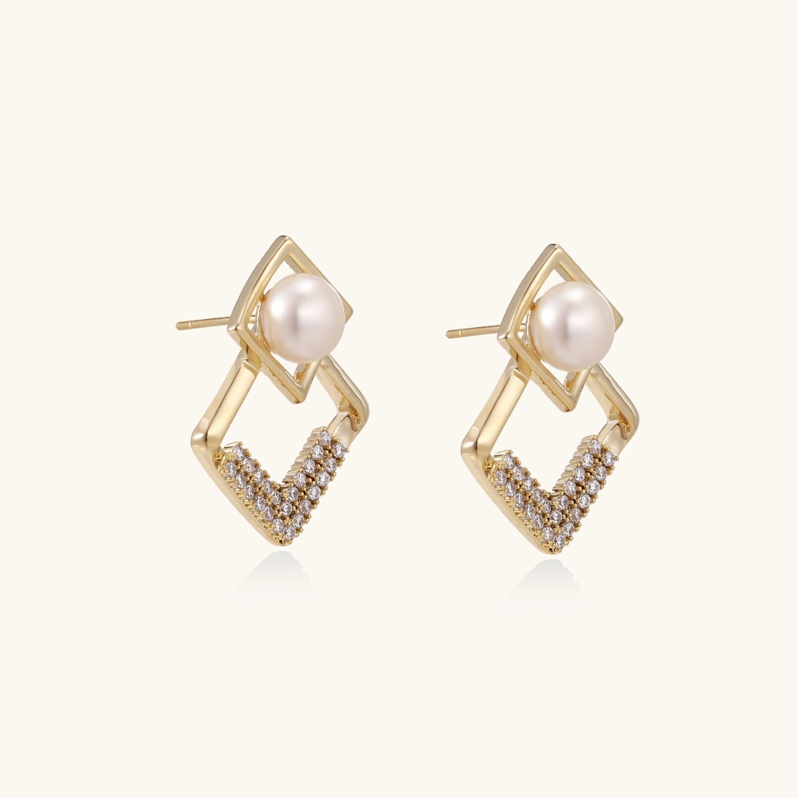 Gold-plated double square frame earrings with freshwater pearl and crystal accents on white background