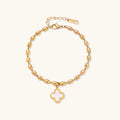 18K gold-plated oval bead chain bracelet with quatrefoil clover charm featuring mother of pearl inlay on cream background
