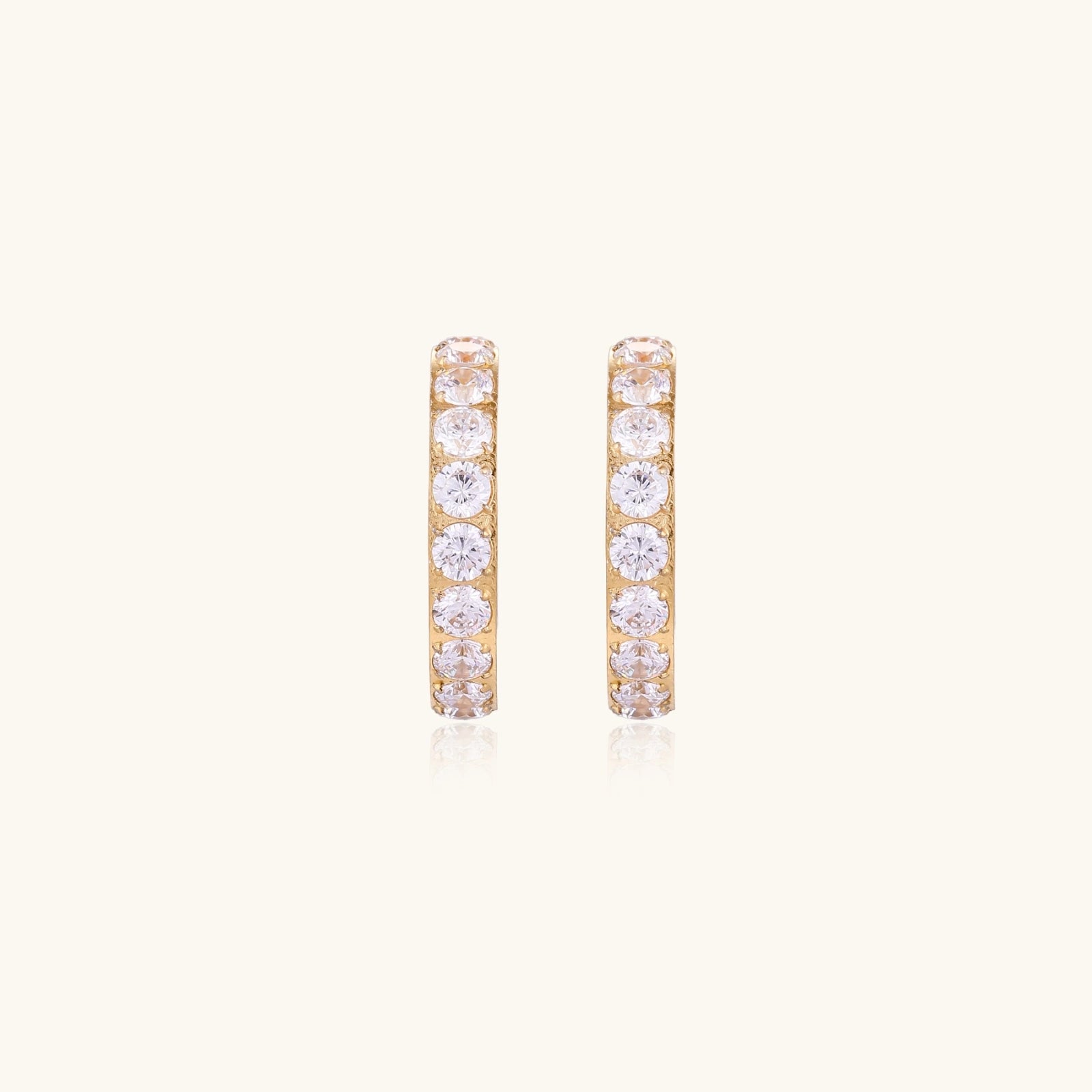 Gold pavé hoop earrings with two freshwater pearls nestled inside the curved design, featuring crystal-studded outer edge.