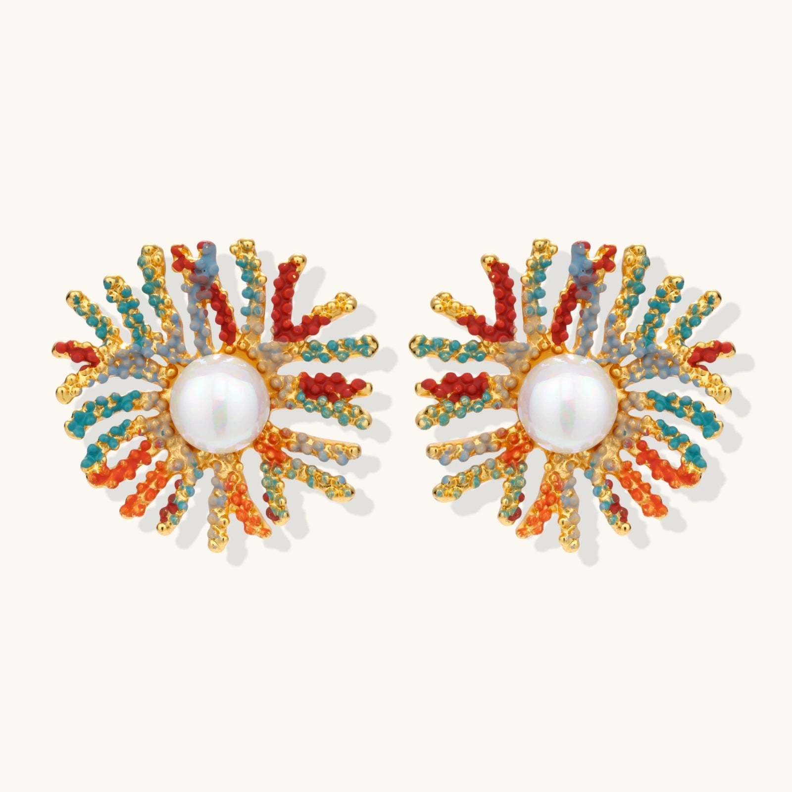 Vibrant starburst stud earrings with multicolor enamel rays and white pearl centers on gold-plated setting