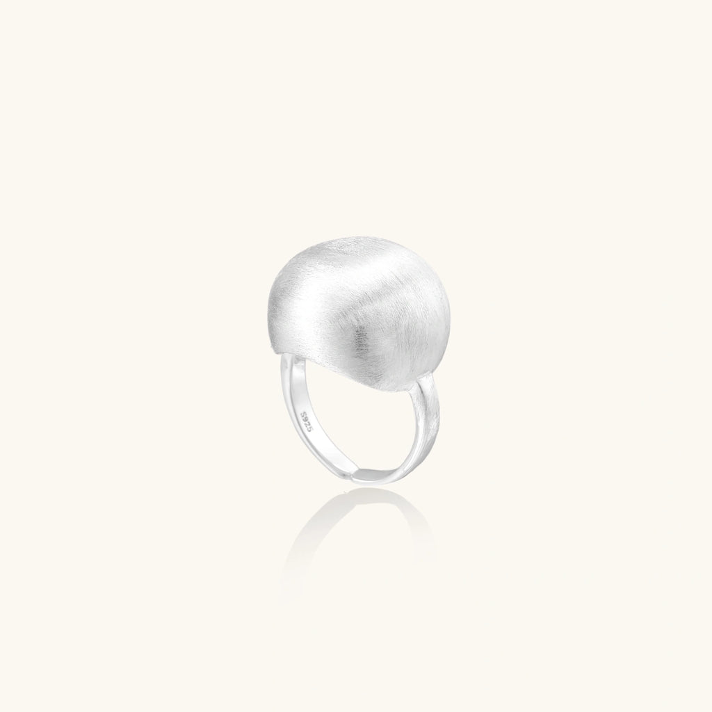 Minimalist brushed sterling silver dome ring with adjustable band on white background, front view.