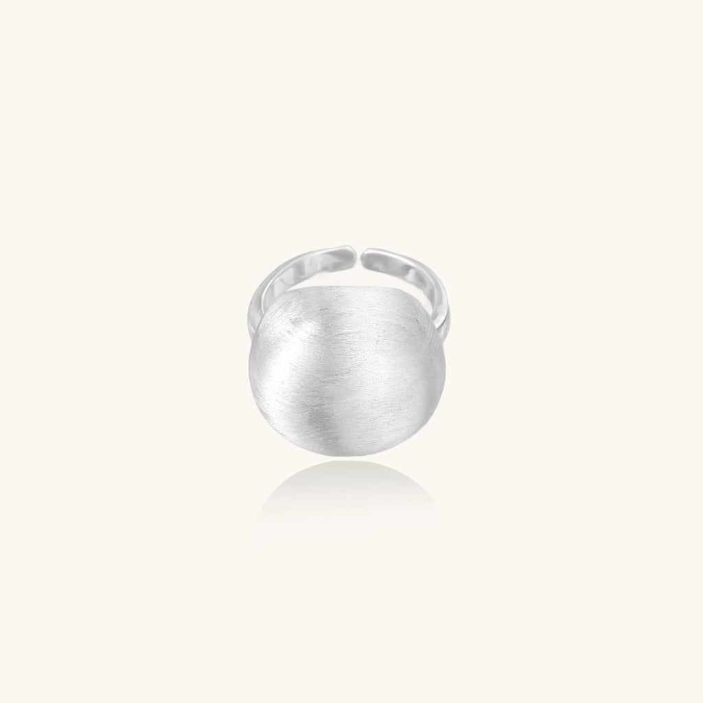 Minimalist brushed sterling silver dome ring with adjustable band on white background, front view.